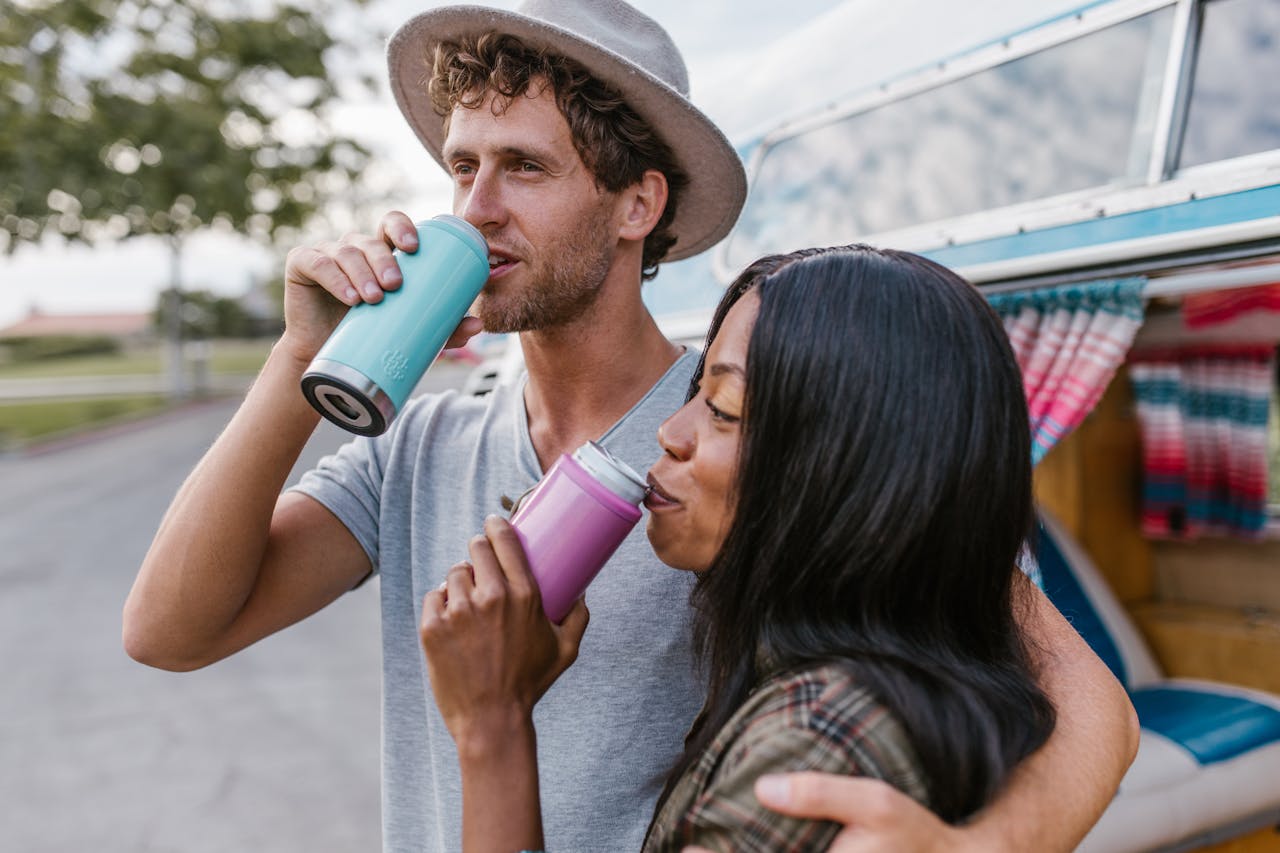 A Man and a Woman Drinking on Tumblers