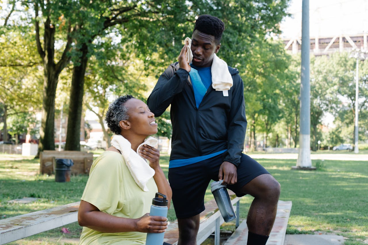 Mother and Son Wiping their Sweat Using Hand Towel